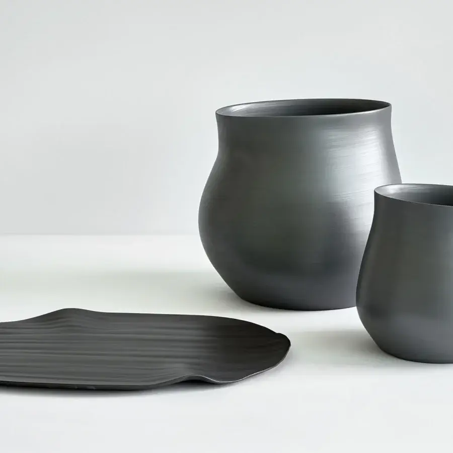 Superior Rina Menardi Agape vessel handcrafted in baked clay with a smooth matte dark gray finish