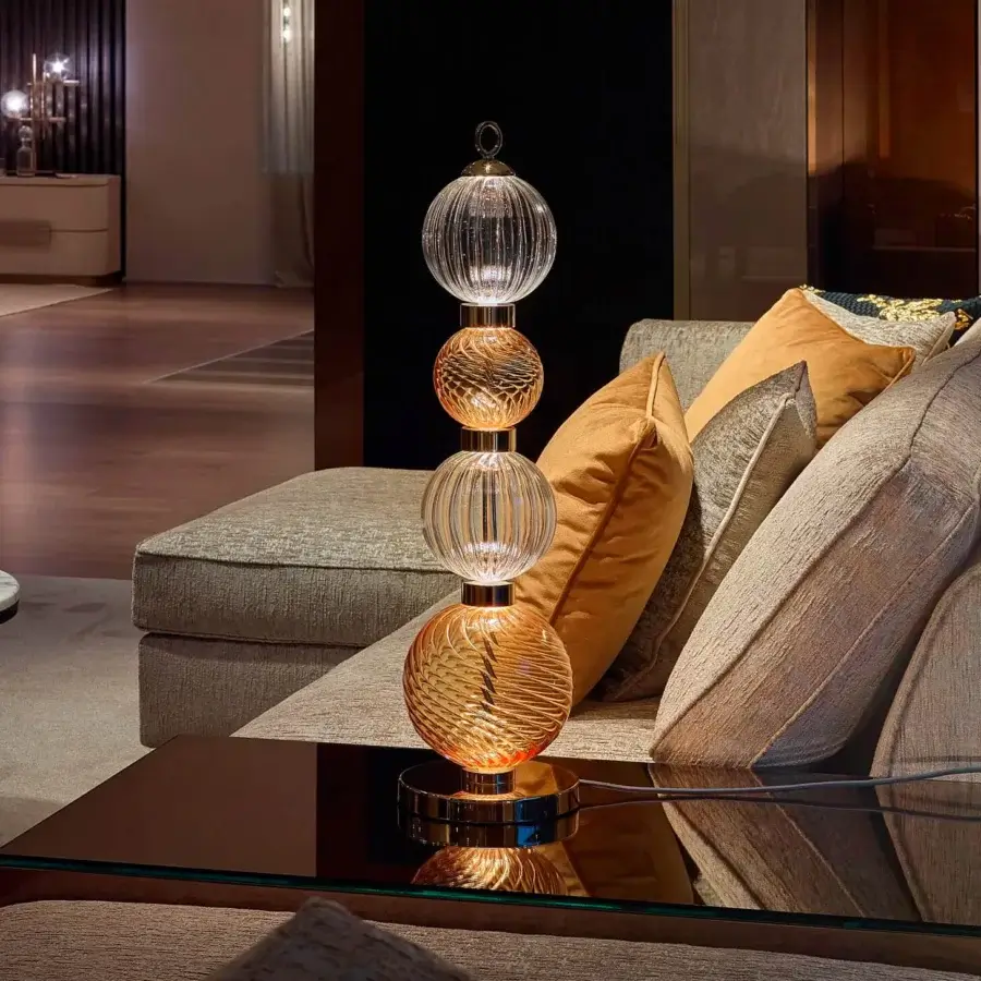Elegant Sicis Drop table lamp crafted in pyrex glass with a satin-finished metal frame in warm amber and clear compositions