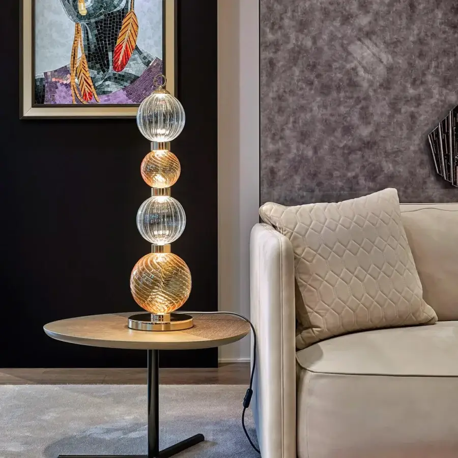 Elegant Sicis Drop table lamp crafted in clear pyrex glass with a satin-finished metal frame and warm metallic interiors