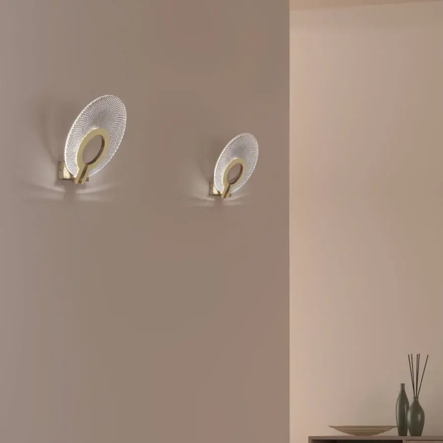 Exceptional Euroluce Corallo wall lamp crafted in metal with a hand-ground satin finish and perforated muted gold shade