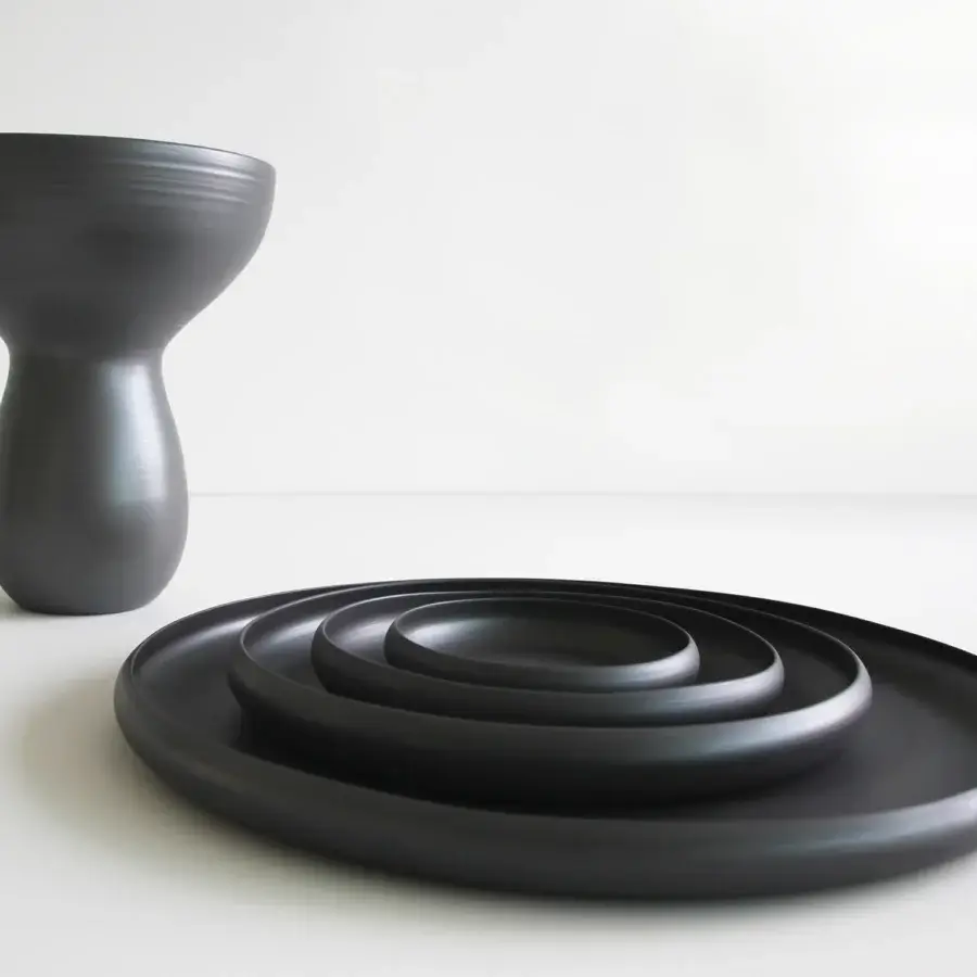 Exceptional Rina Menardi Bouquet vessel crafted in dark gray baked clay with a slender form and unique artisanal details