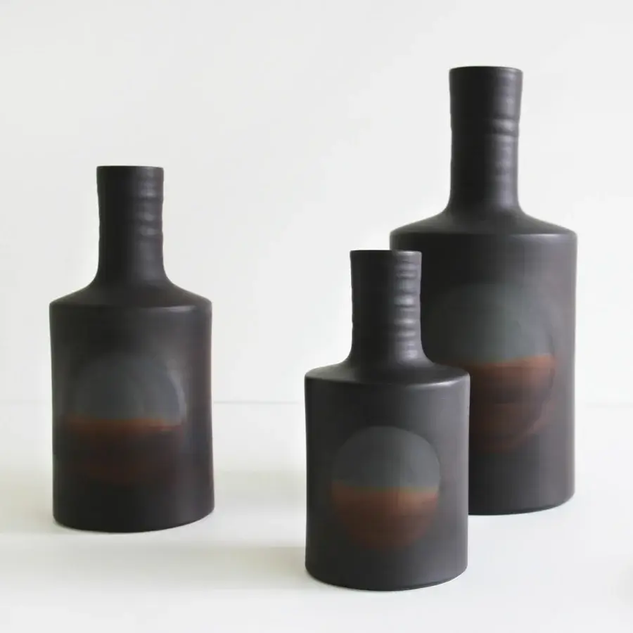 Exceptional Rina Menardi Oblo' vase crafted in baked clay with a muted brown gradient and textured matte finish