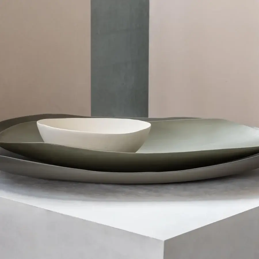Elegant Rina Menardi Petali centerpiece crafted in baked clay with flowing curved lines and muted olive-green finish