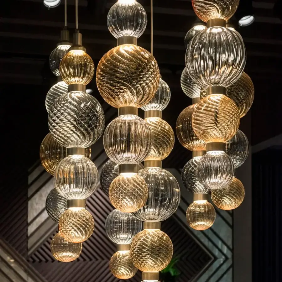 Superior Sicis Drop suspension lamp crafted in amber, gold, silver and clear hand-blown Pyrex glass with satin metal frames