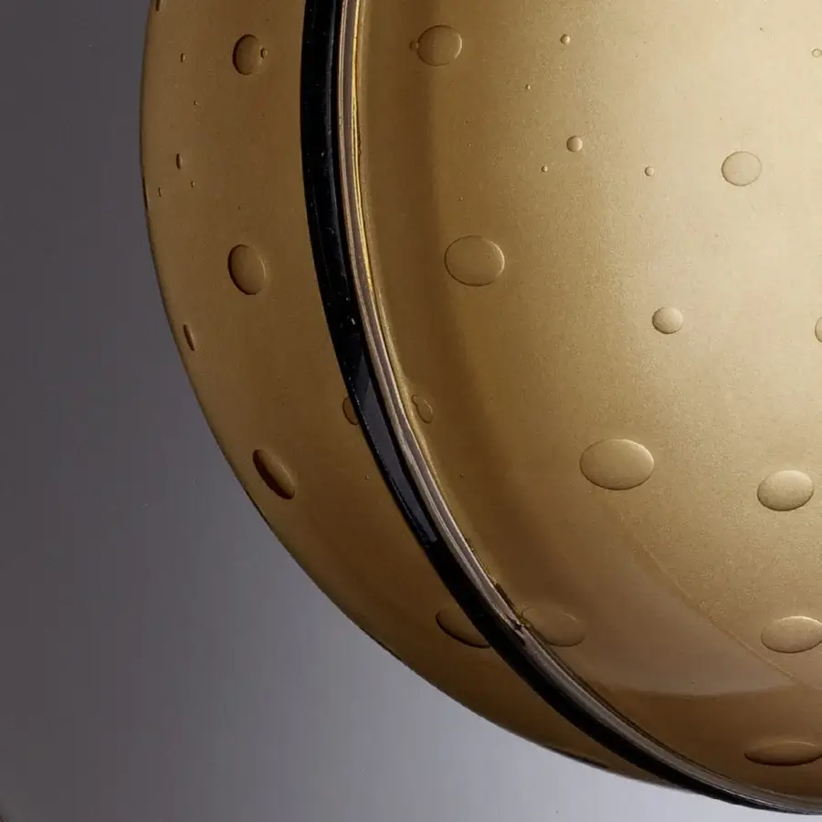 Distinguished Euroluce Illusione wall lamp with a mirrored chrome finish and textured circular indentations delivering a contemporary aesthetic