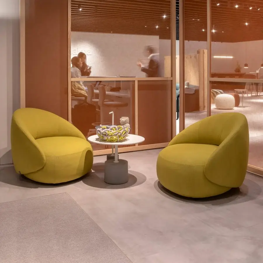 Distinguished Lapalma Kipu Club lounge chair with ergonomic backrest upholstered in muted golden yellow textile, evoking a contemporary relaxed aesthetic