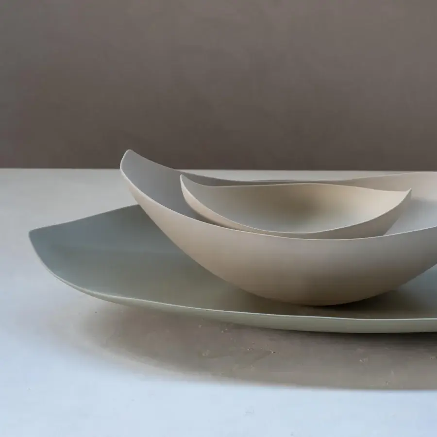 Superior Rina Menardi Barchette centerpiece crafted in baked clay with a matte pale beige finish and sage green tray