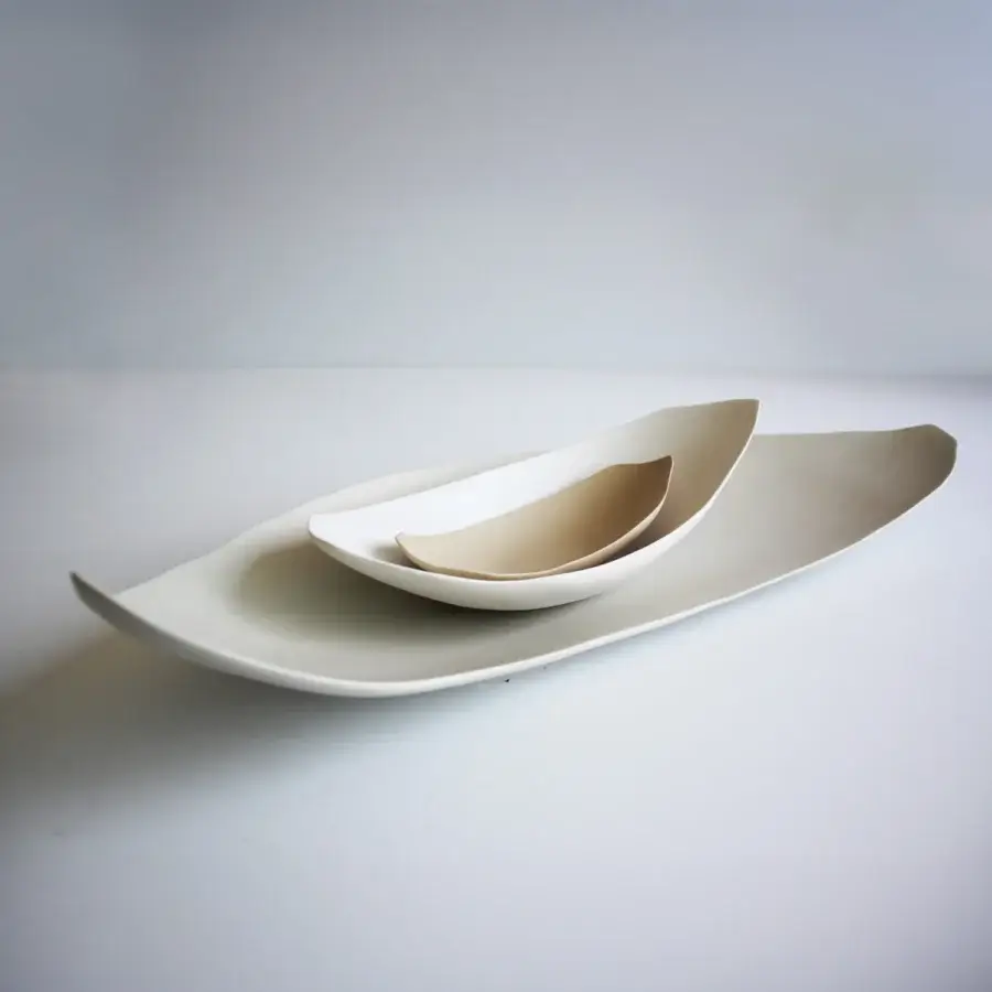 Elegant Rina Menardi Barchette centerpiece crafted in baked clay with a smooth matte finish and gently curved silhouettes