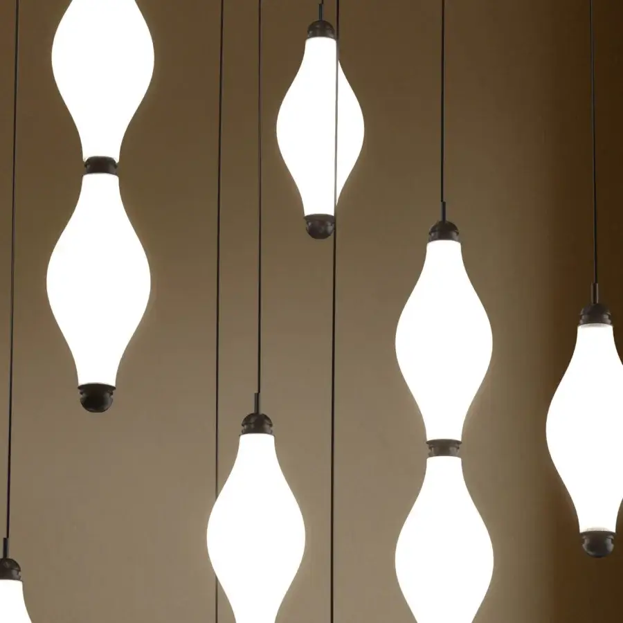 Superior Euroluce Dewy suspension lamp crafted in slightly textured glass with dark matte metal components emitting a warm white glow