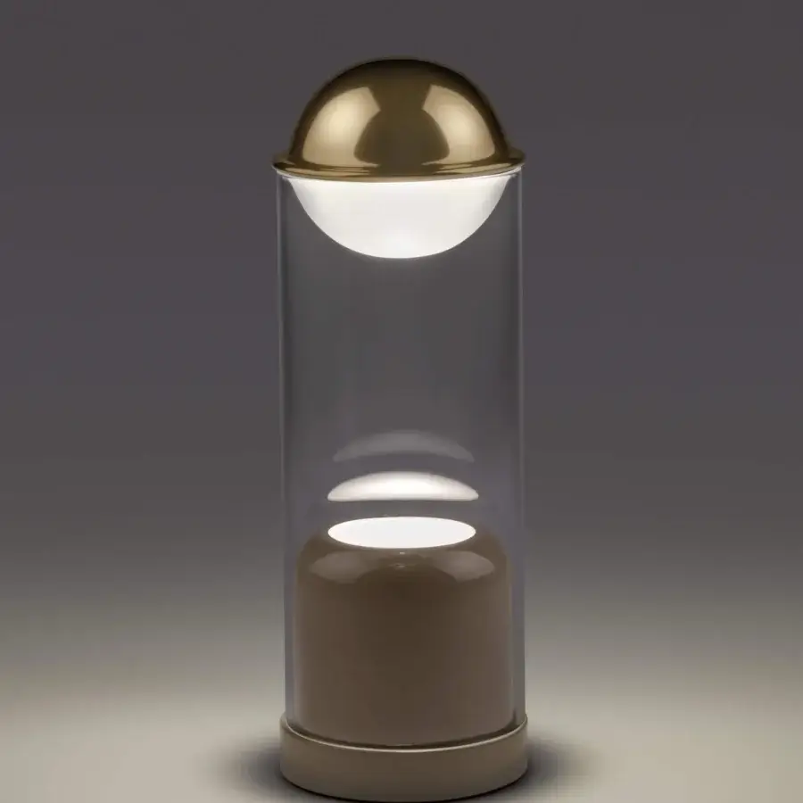 Exceptional Euroluce Theorem table lamp with illuminated sand in clear glass and glossy golden metal dome
