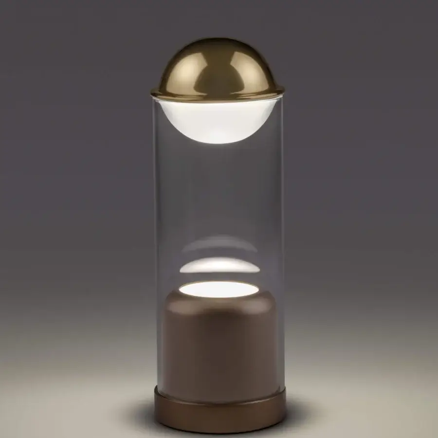 Elegant Euroluce Theorem table lamp with two-tone borosilicate glass and muted gold-toned metal dome crafted in a cylindrical silhouette