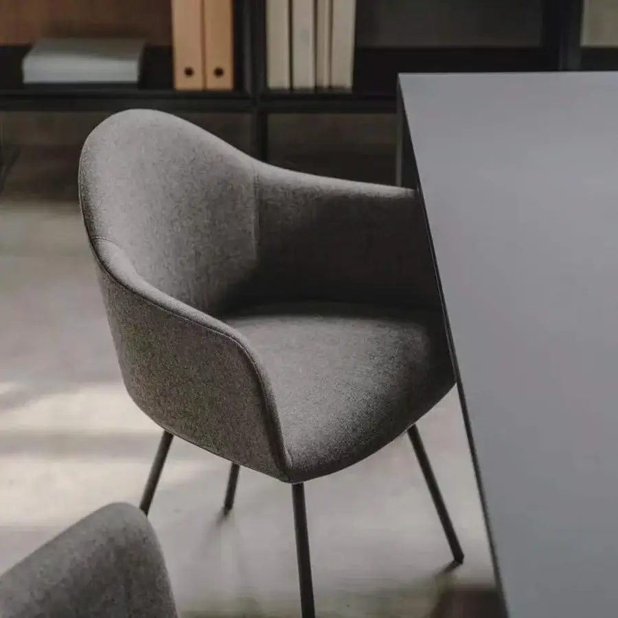 Distinguished Lapalma Edit armchair with rigid shell upholstered in textured medium gray fabric and matte steel legs
