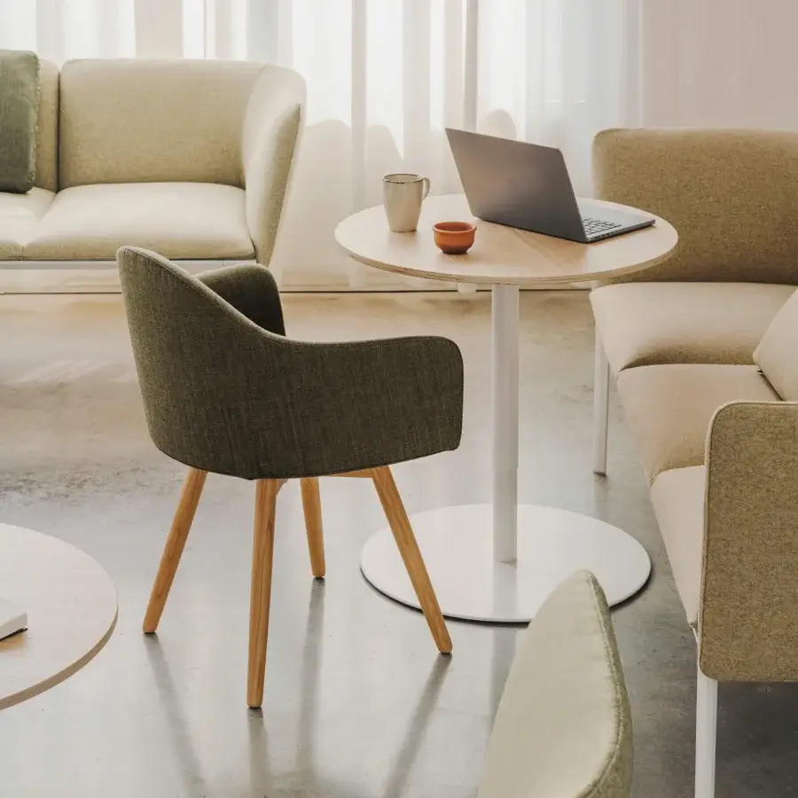Lavish Lapalma Edit armchair with gently curved shell upholstered in muted olive green fabric and varnished solid ash legs