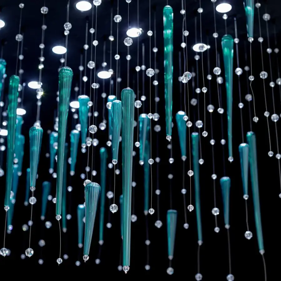 Captivating Euroluce Reflessi Linear Suspension Lamp with cascading teal and clear glass tubes suspended by polished metallic wires
