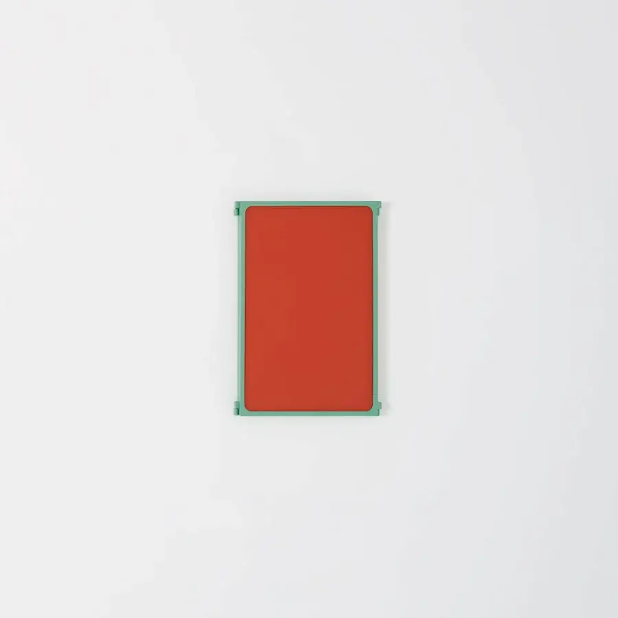 Distinguished Glas Italia Como mirror in shiny-polished solid brass with reddish-orange and muted teal-green panels and matt lacquered finish