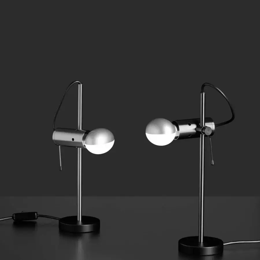 Elegant Oluce Agnoli table lamp crafted in metal with a satin finish and silver-toned adjustable arm