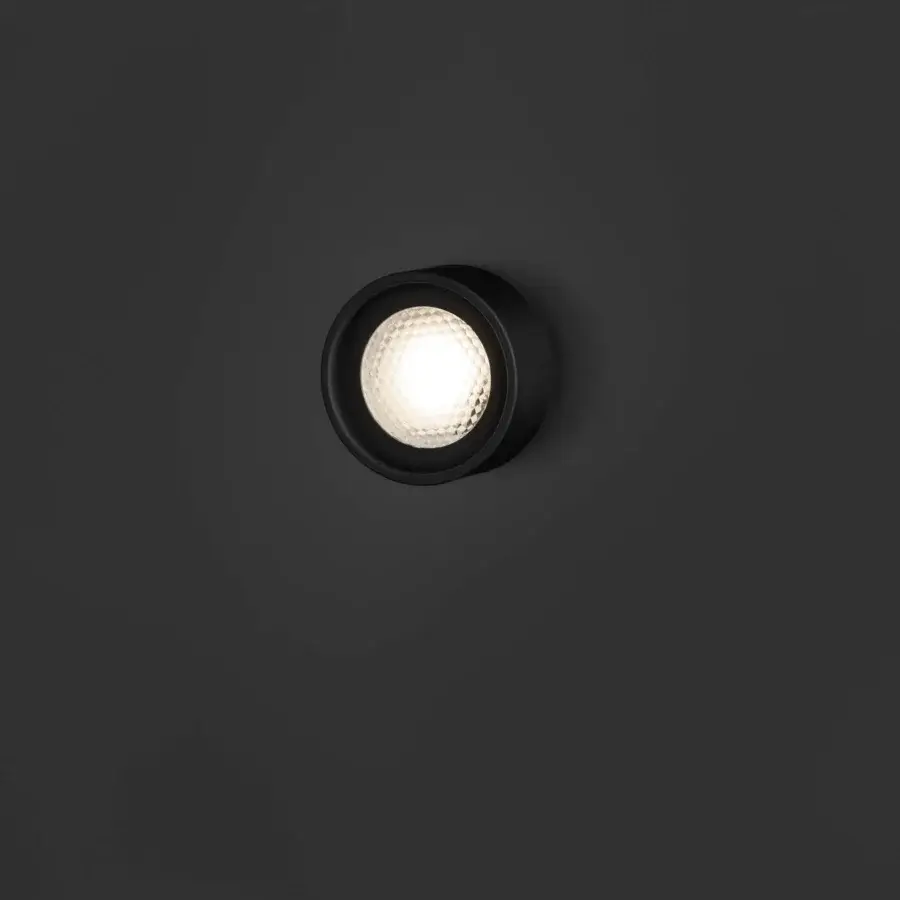 Superior Oluce Berlin-Out lamp crafted in matte black metal with a warm white faceted diffuser and rotatable design