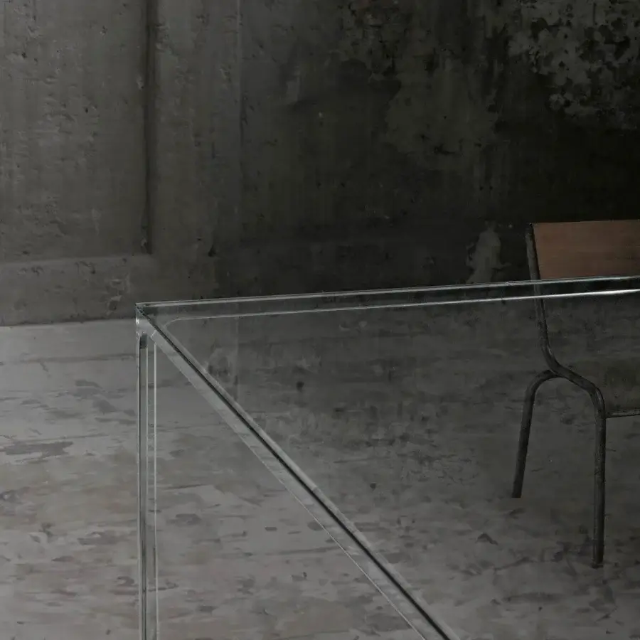 Elegant Glas Italia Oscar table with transparent extralight glass and dark matte metal base
