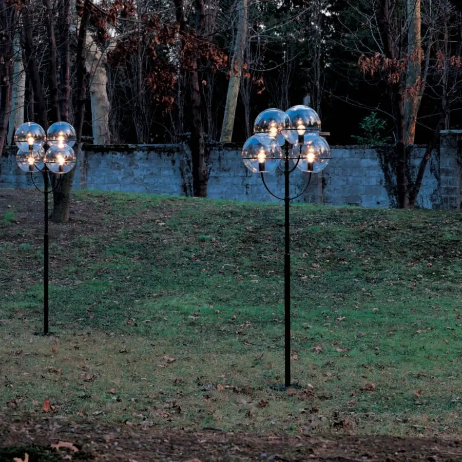 Elegant Oluce Lyndon floor lamp with a dark matte metal stem and four transparent polycarbonate spheres