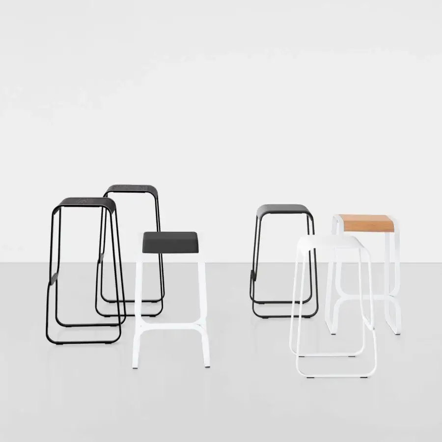 Innovative Lapalma Continuum stool built with black bent metal and a light natural wood seat exhibiting a smooth finish