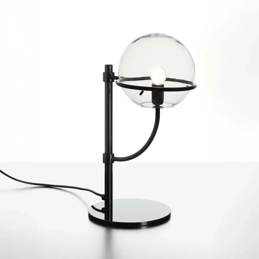 Elegant Oluce Lyndon table lamp with a sleek matte black metal frame and transparent polycarbonate sphere