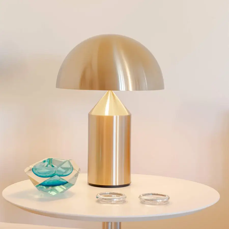 Elegant Oluce Atollo Metal Table Lamp in warm light gold with a glossy smooth surface and harmonious geometric form