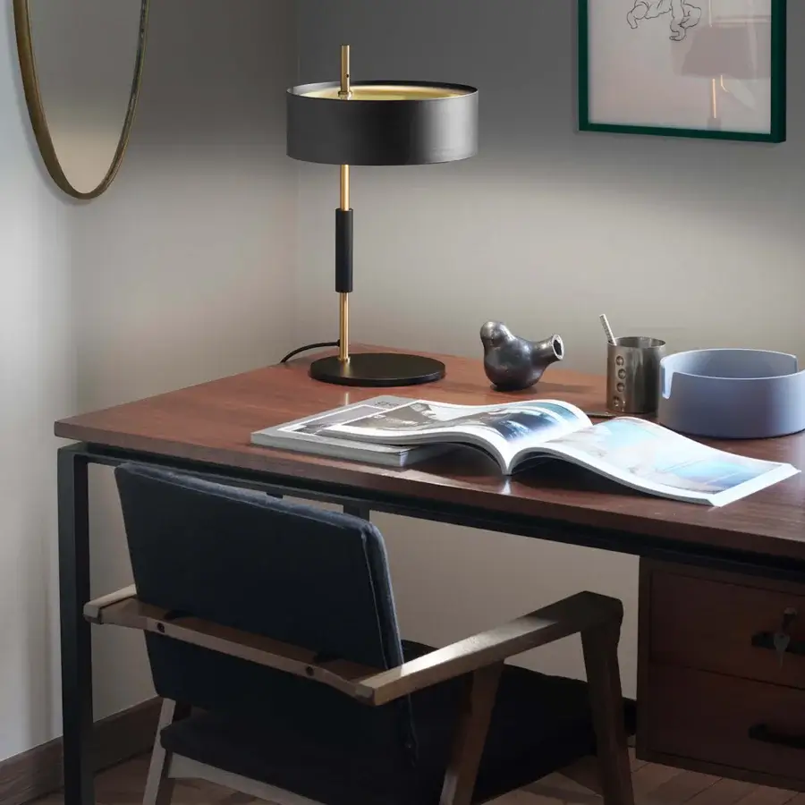 Elegant Oluce 1953 lamp crafted in polished gold-tone metal with a translucent glass shade embodying Italian design