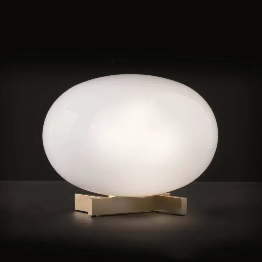 Elegant Oluce Alba table lamp with bright white organically-shaped shade and brass-toned metal base crafted in Italy with a satin finish