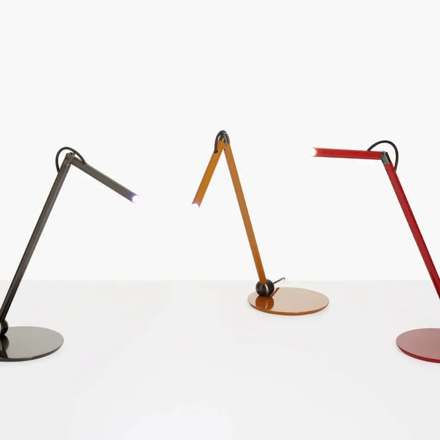 Elegant Oluce Calamaio table lamp crafted from metal in a glossy deep red with a minimalist geometric form