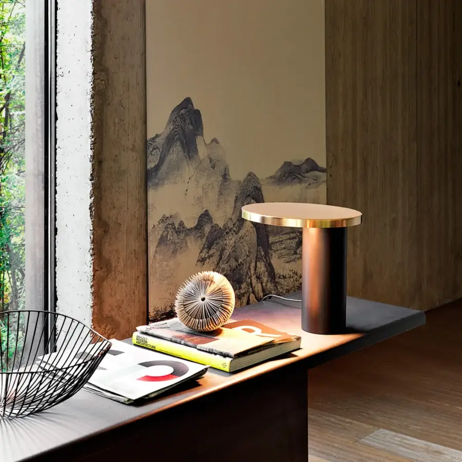 Superior Oluce Cylinda lamp crafted in metal with a dark base and golden metallic lampshade exhibiting satin finish