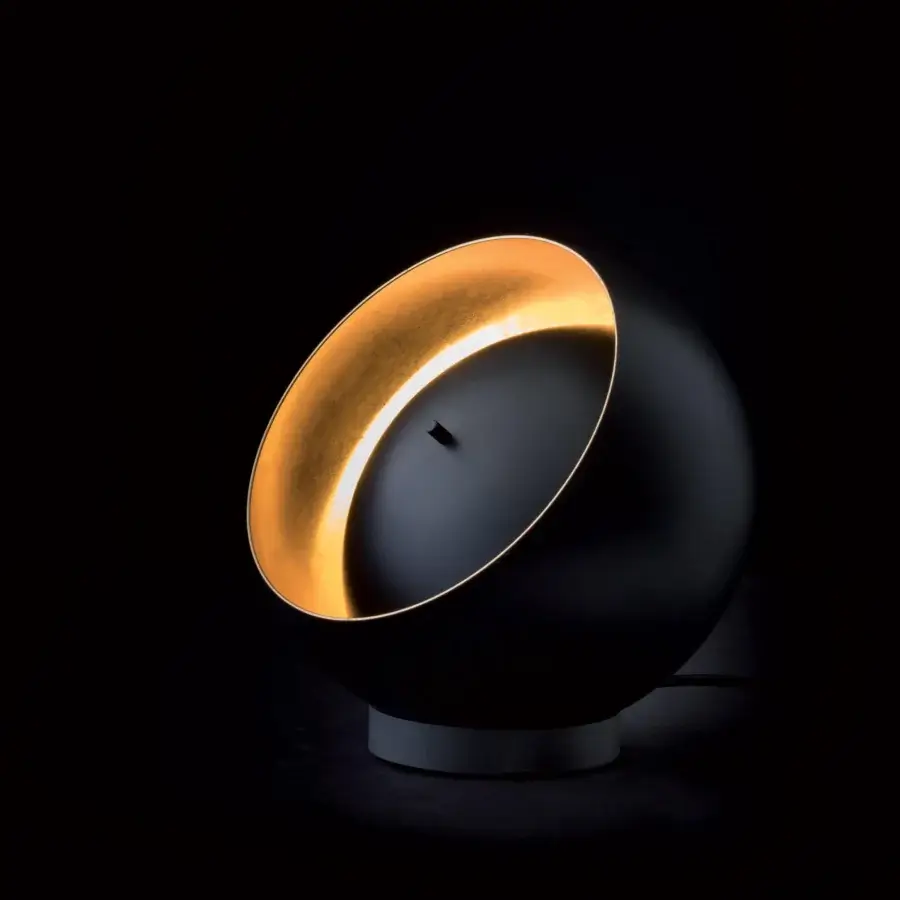 Elegant Oluce Eva lamp crafted in dark metal with a gold-leaf interior revealing adjustable spiral illumination