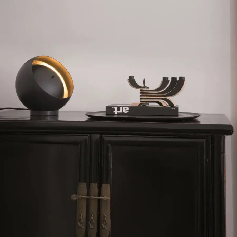 Superior Oluce Eva lamp crafted in matte black metal with a unique adjustable opening revealing gold-leaf interior
