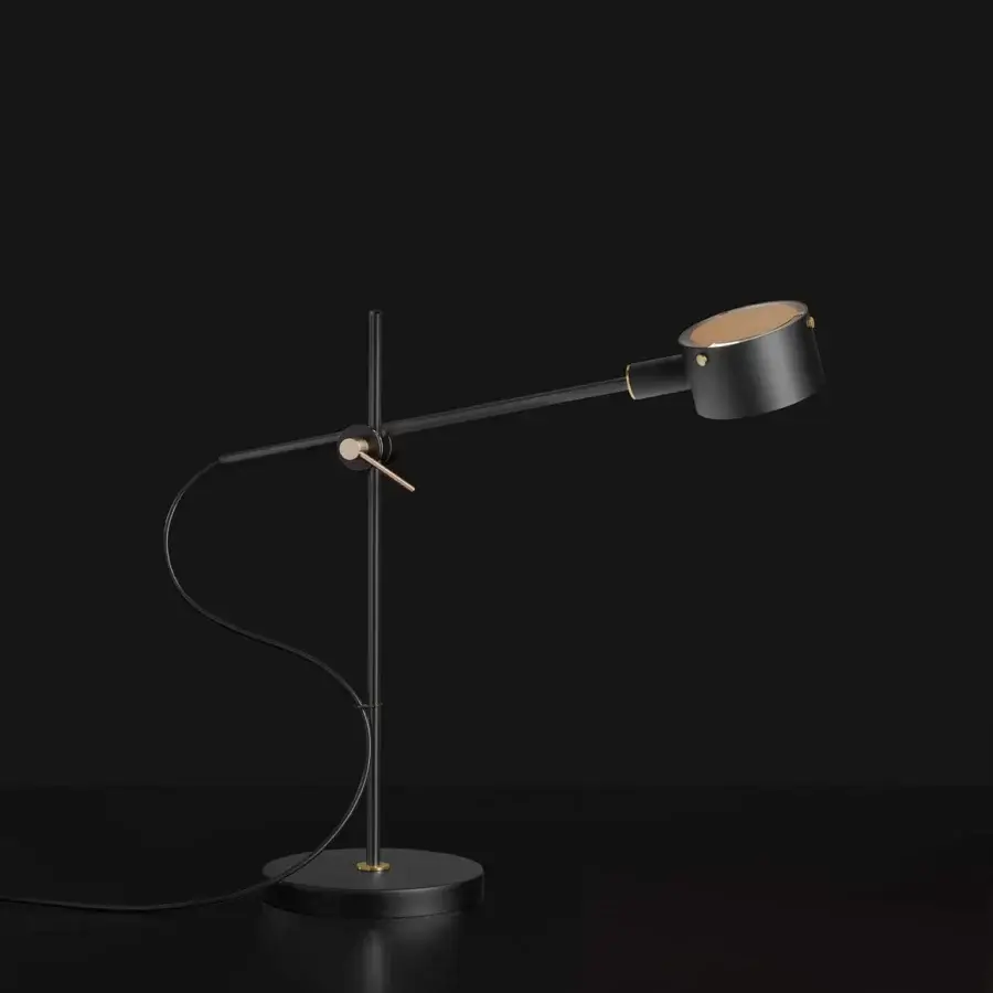 Elegant Oluce G.O table lamp crafted in metal with matte black finish and warm gold-toned joints for flexible positioning