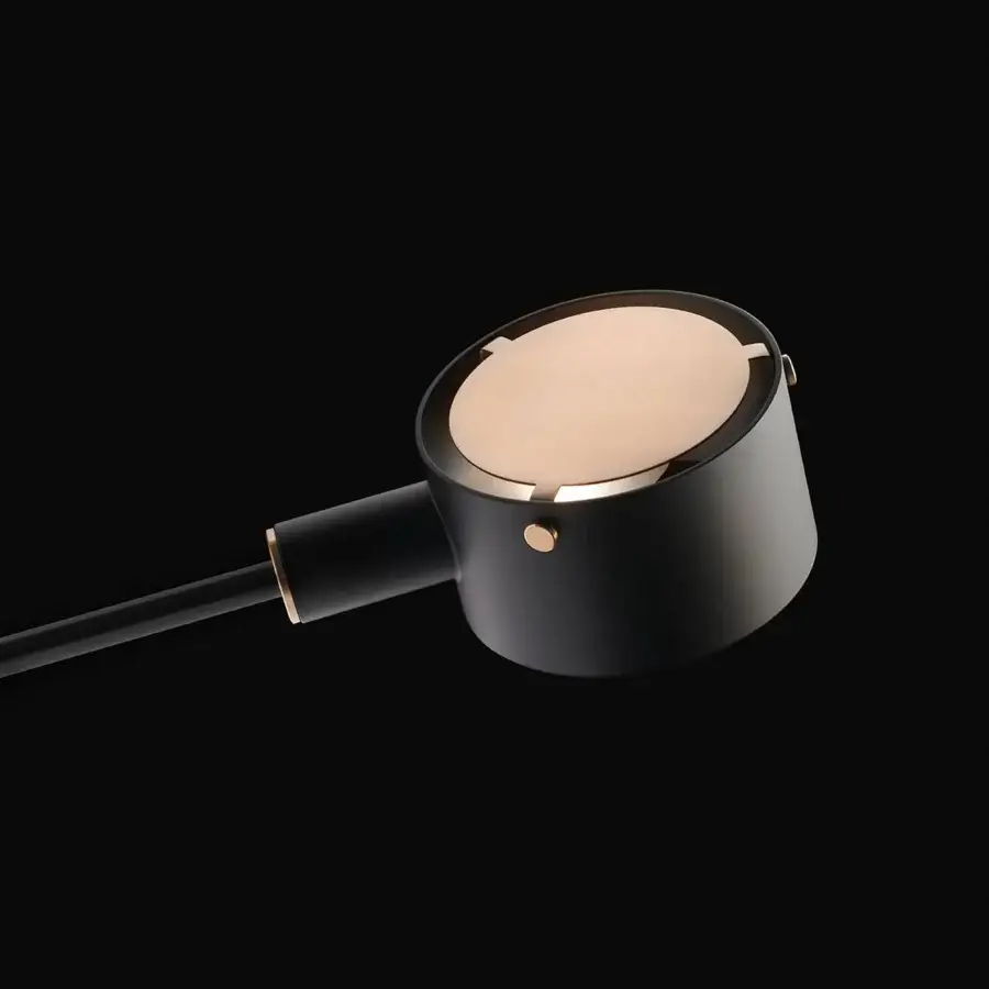 Distinguished Oluce G.O table lamp crafted in dark gray metal with rose-gold inset and matte finish