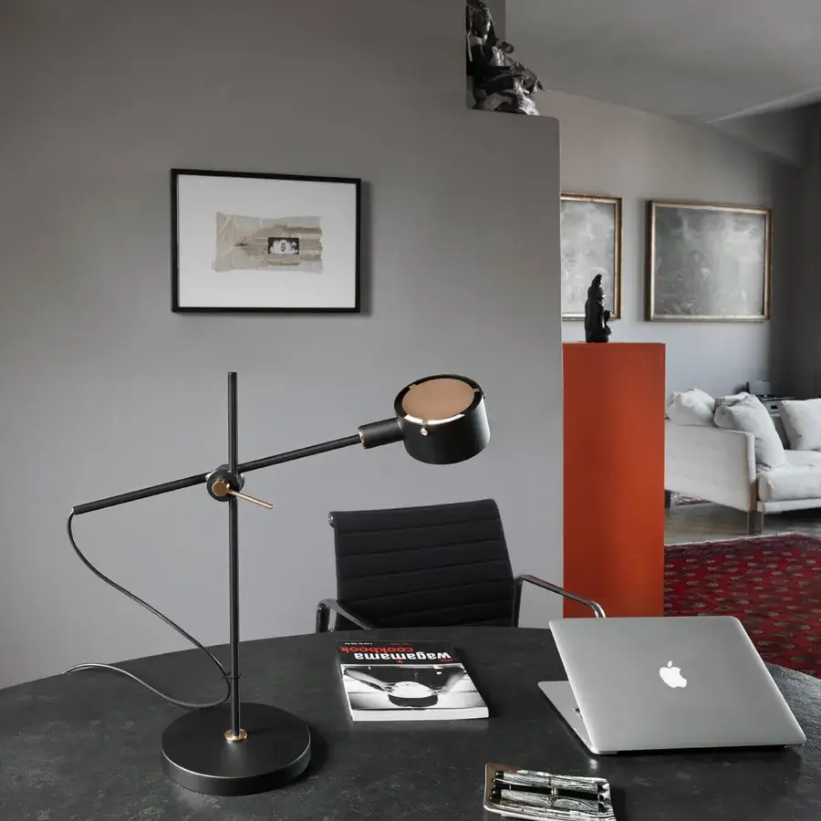 Distinguished Oluce G.O. table lamp with angular form and extending arms in black metal with brass-toned joints and a smooth matte finish