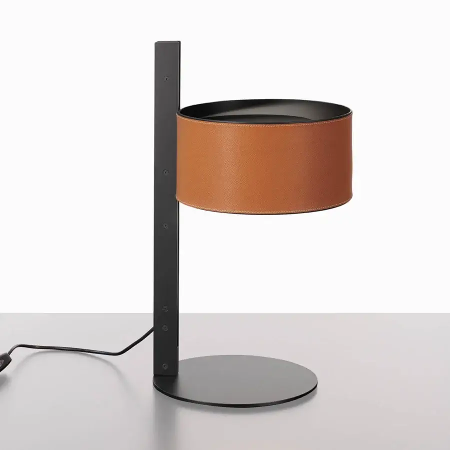 Superior Oluce Parallel table lamp in sleek black metal with a central band of reddish-brown hammered leather