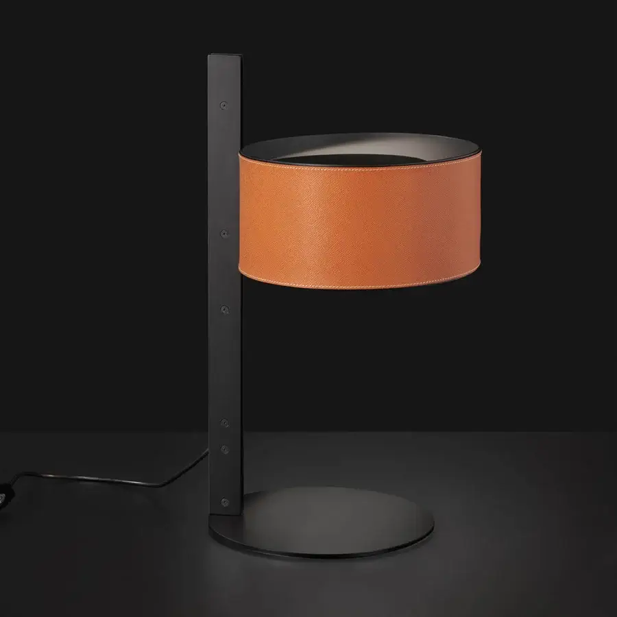 Exclusive Oluce Parallel table lamp crafted in reddish-brown hammered leather with a dark matte metal frame and base