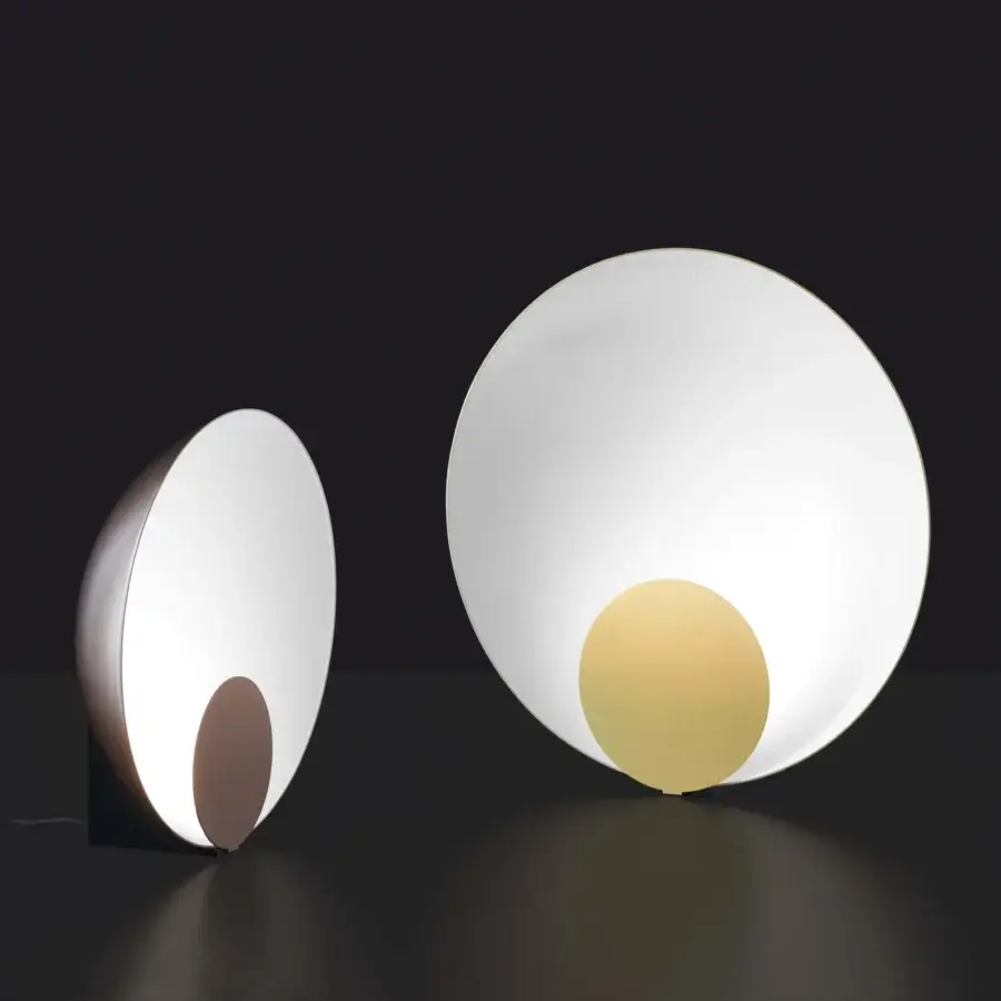 Refined Oluce Siro lamp with a semi-spherical form and warm yellow inner shade in crisp white, crafted with a matte finish