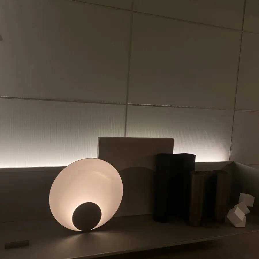 Elegant Oluce Siro lamp with a semi-spherical white form and gradient toward the illuminated opening crafted in Italy with a matte finish