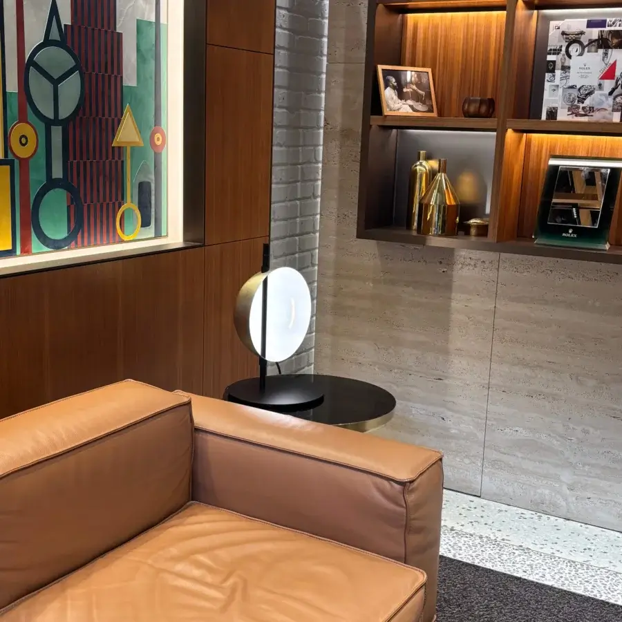 Distinguished Oluce Superluna lamp with a matte white spherical shade and slender black metal base embodying contemporary illumination