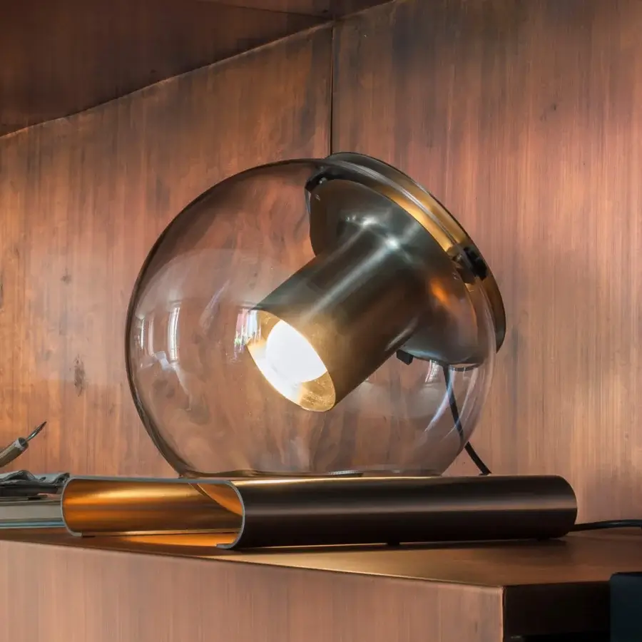 Superior Oluce Globe Table Lamp with transparent blown-glass and satin-finish metal in warm amber and bronze hues