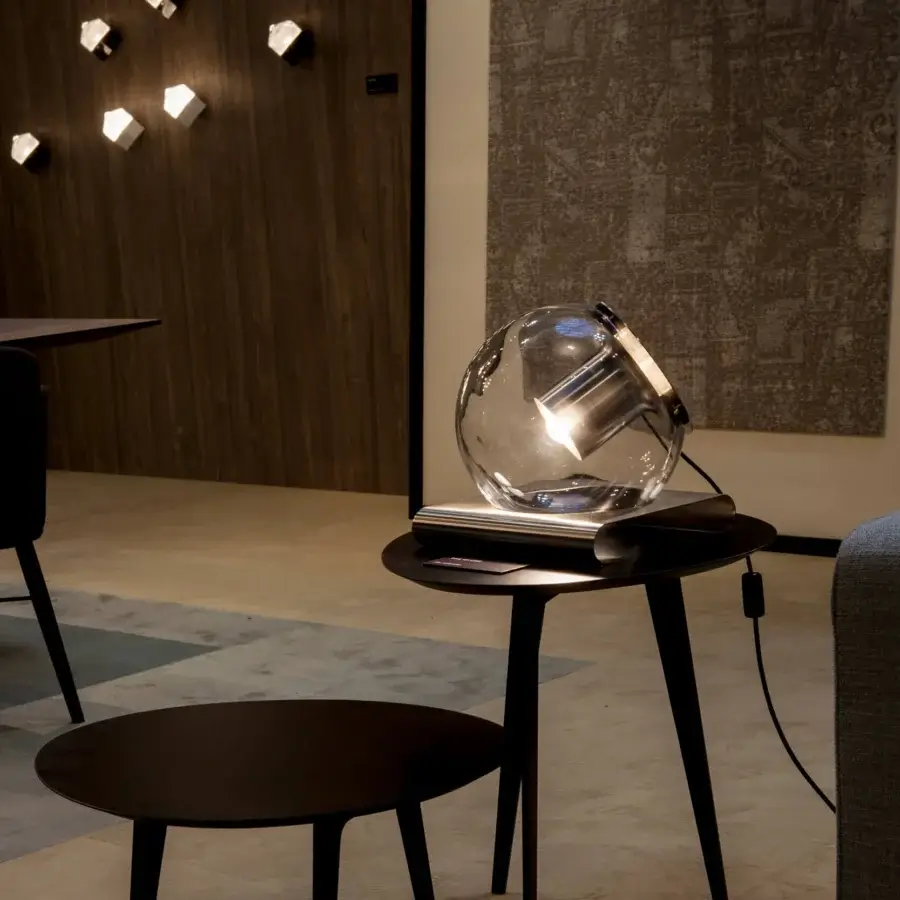 Elegant Oluce Globe Table Lamp with transparent blown-glass sphere and dark-toned wooden base crafted with splayed satin legs