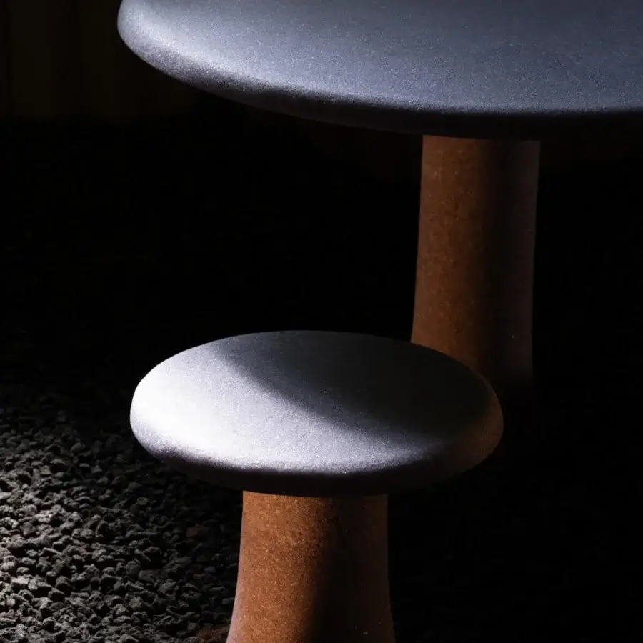 Meticulous Glas Italia Babar side table built in recycled glass grit with a matte dark gray tabletop and reddish-brown hourglass pedestal