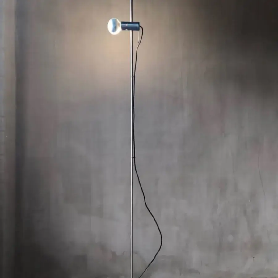 Superior Oluce Agnoli floor lamp crafted in dark gray metal with a refined travertine base and smooth matte finish