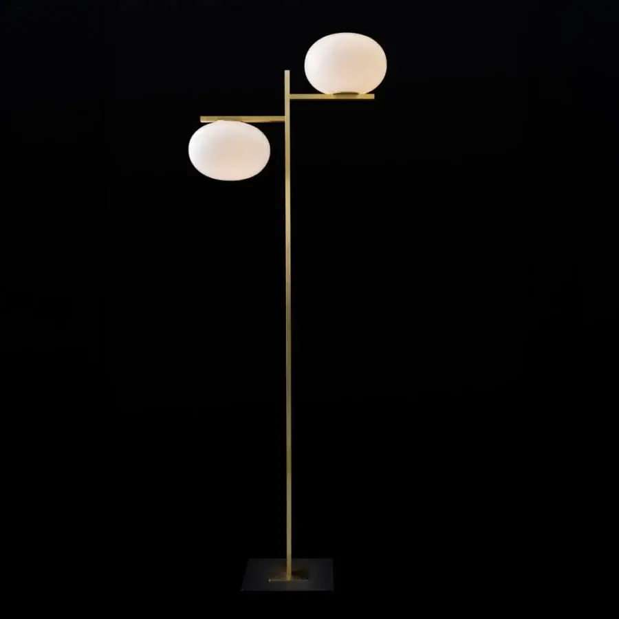 Elegant Oluce Alba floor lamp in polished golden metal with offset opaque white spherical shades