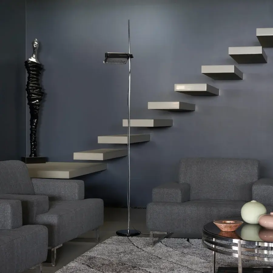 Exclusive Oluce Colombo floor lamp with polished metal and matte black adjustable reflector embodies sleek modern lines