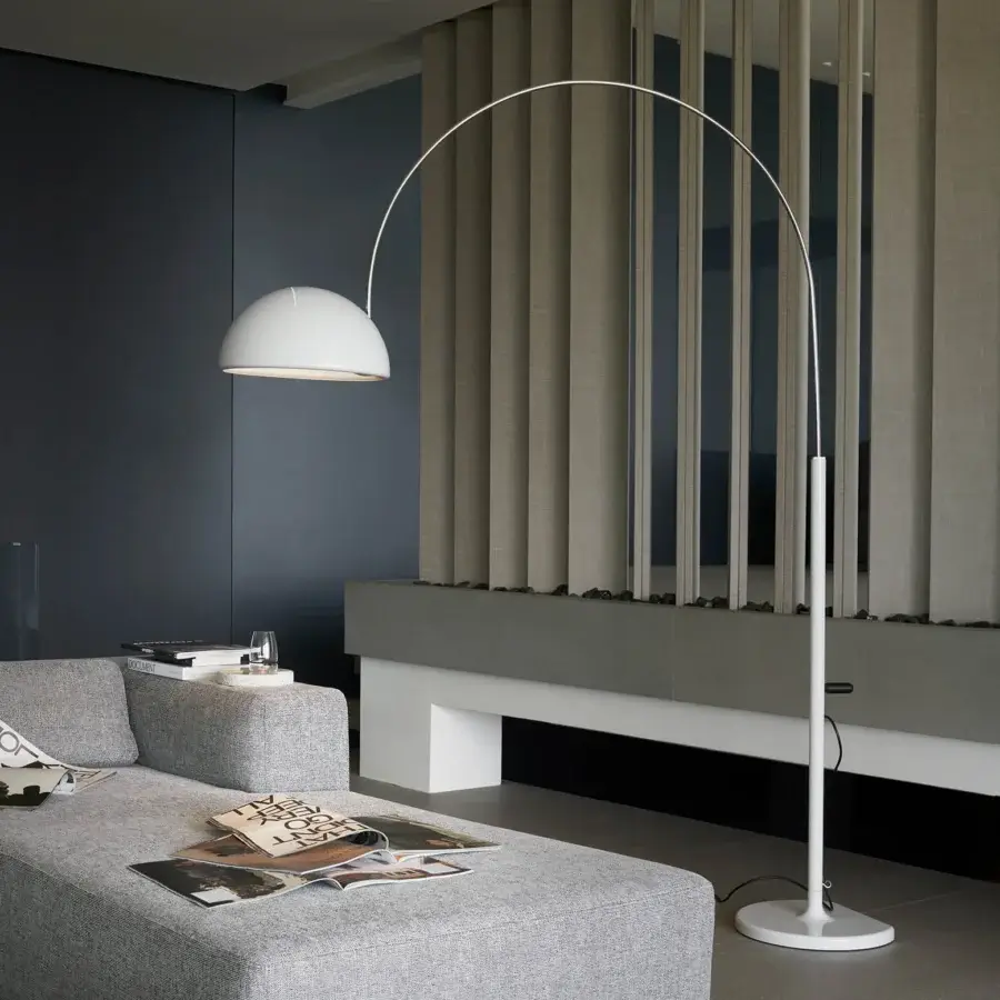 Exclusive Oluce Coupé arched floor lamp with a flowing white silhouette and smooth satin metal finish