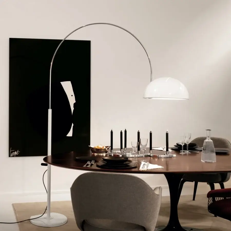 Distinguished Oluce Coupé arched floor lamp with a sweeping silhouette and satin white metal finish crafted in Italy