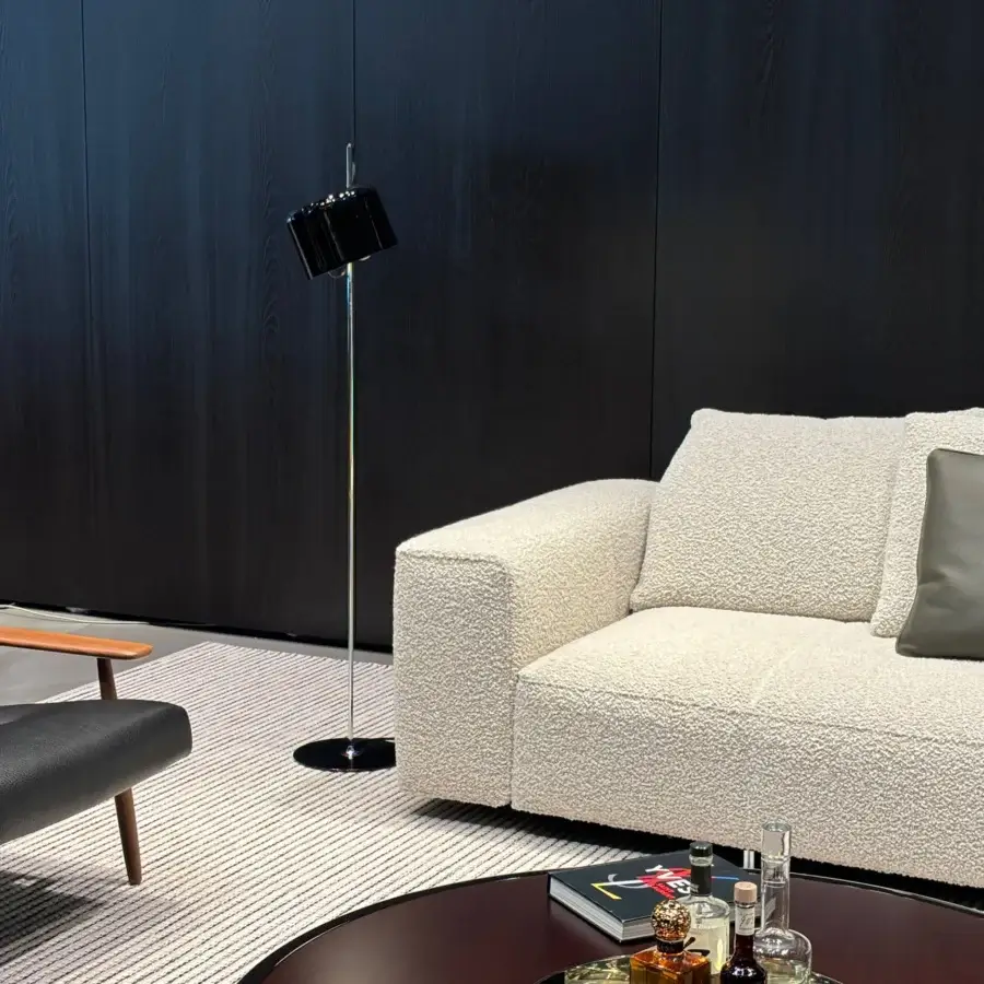 Exceptional Oluce Coupé floor lamp with a glossy black metal stem and polished metal coupe-shaped shade offering adjustable light