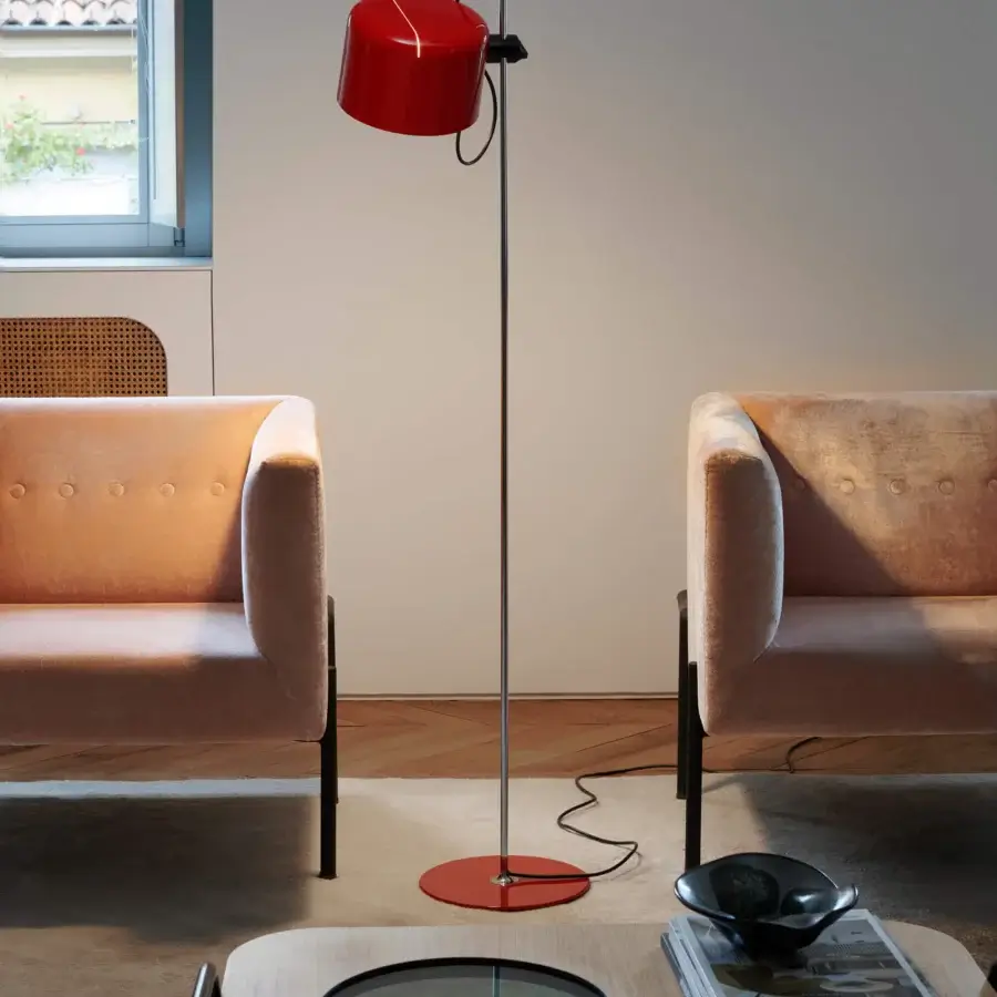 Distinguished Oluce Coupé floor lamp with a vibrant red glossy metal shade and sleek black metal stem offering directional light